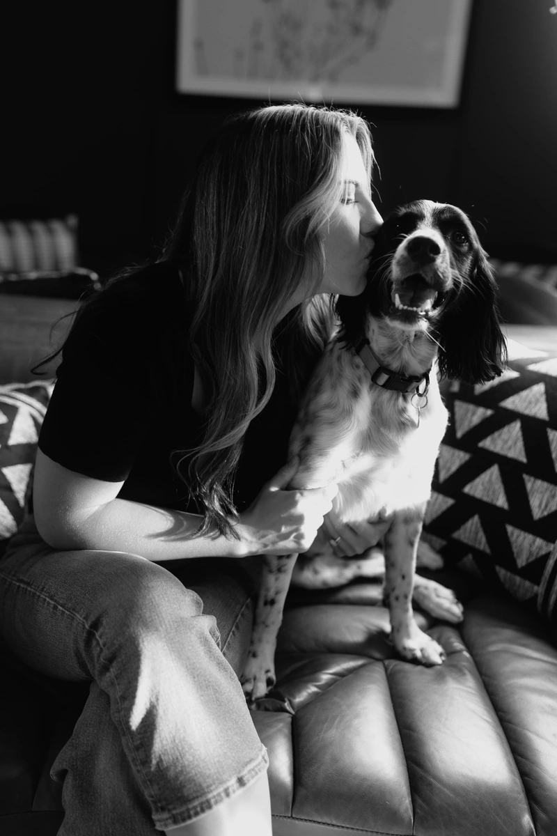 Maya, owner of Wild Honey Massage, sitting with her dog